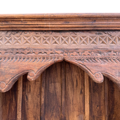 Hand carved foliate and geometric motifs on oak bookcase frieze