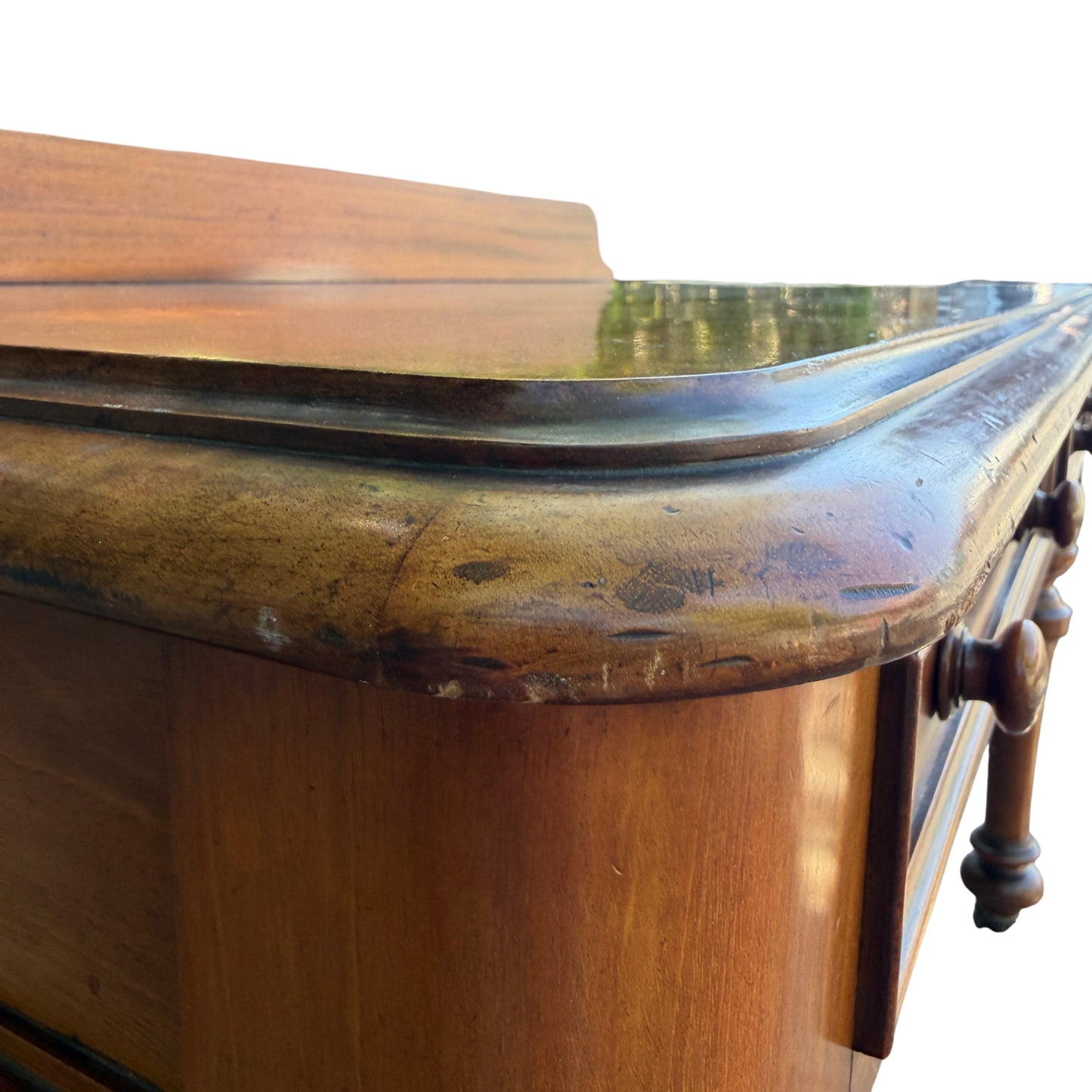 Close-up of edge wear and surface scratches on console table top
