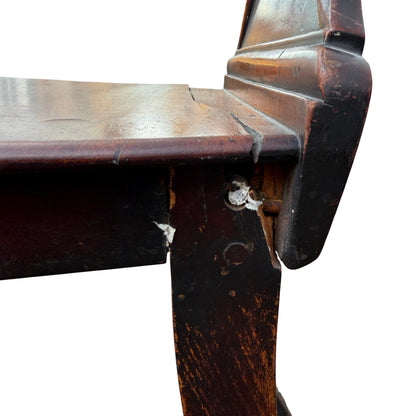 Close-up of worn finish and scratches on mahogany seat board