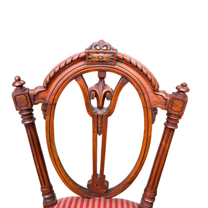 Detail of turned front legs and carved seat rail on a Victorian dining chair