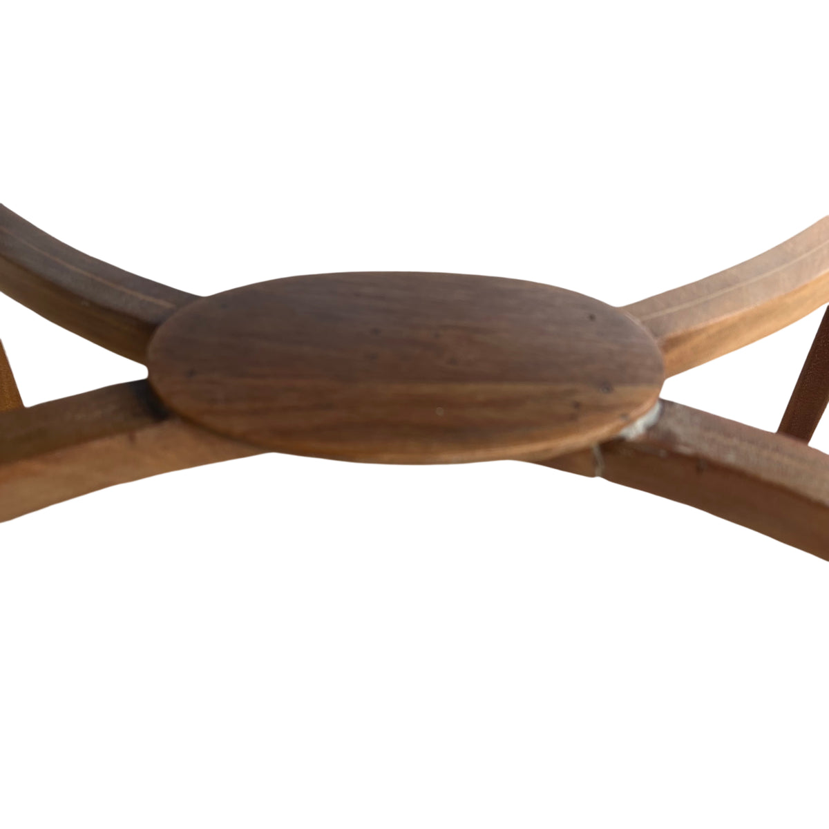 Round occasional table top showing wood grain and surface wear