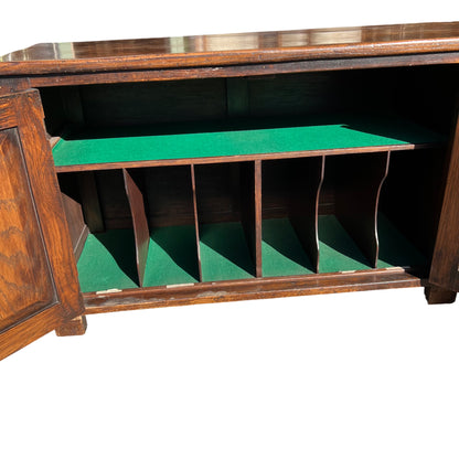 Front view of long oak sideboard with symmetrical carved tracery on doors