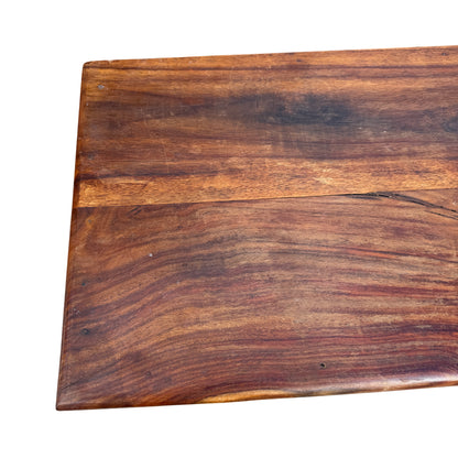 Angled view of two columns of recessed drawers on a rustic wooden chest