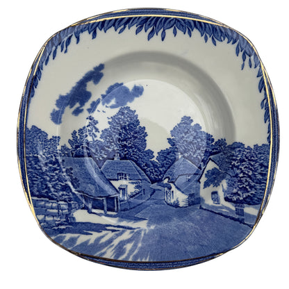 Edge detail showing gilt wear and blue transferware border on vintage Burleigh bowl