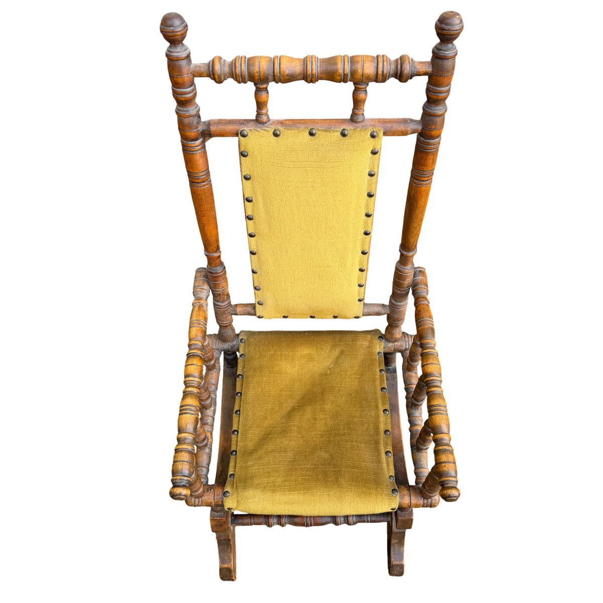 Detail of worn upholstery pile and small marks on vintage child's rocker