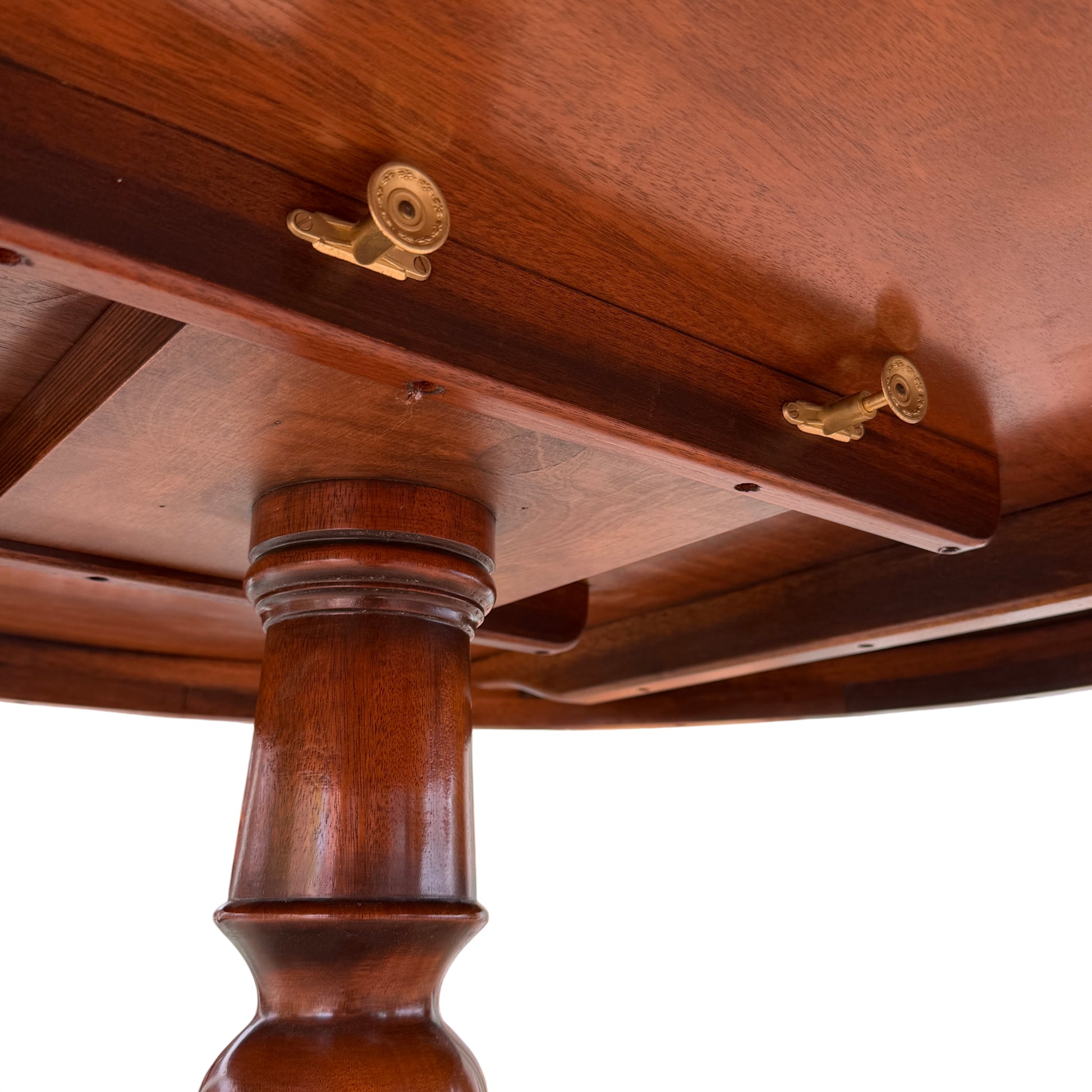 Dining table set shown from the front with pedestal base and feet visible