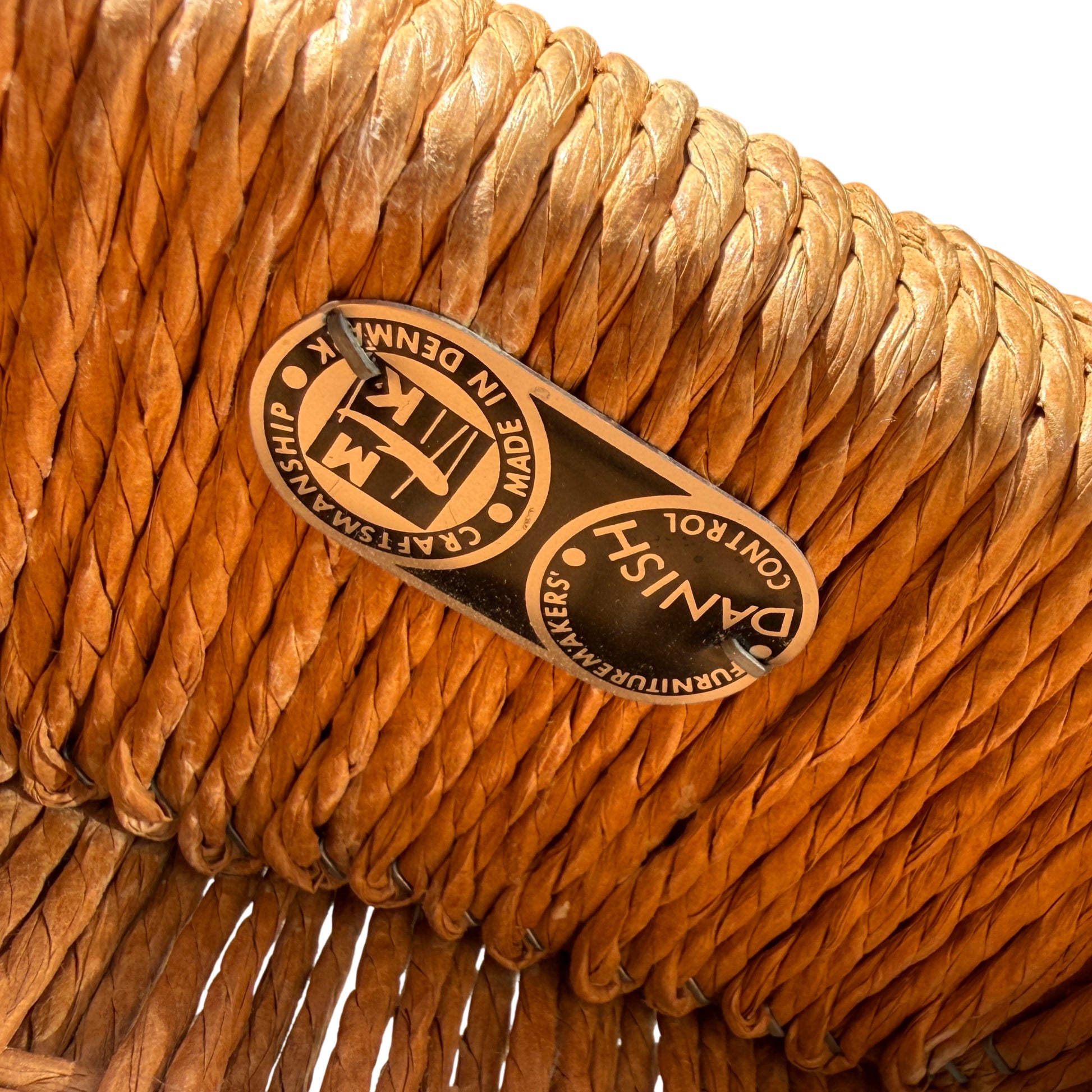 Close-up of curved teak backrest and top of armrests on mid-century dining chair