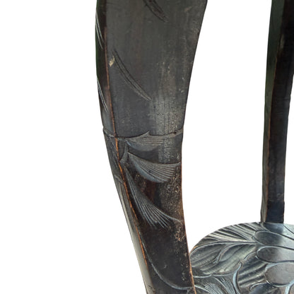 Lower shelf carved with matching floral motif on vintage side table