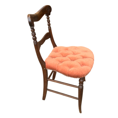 Side view showing turned rear uprights and carved back of a vintage dining chair