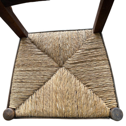 Side view of vintage solid wood dining chair and turned front leg