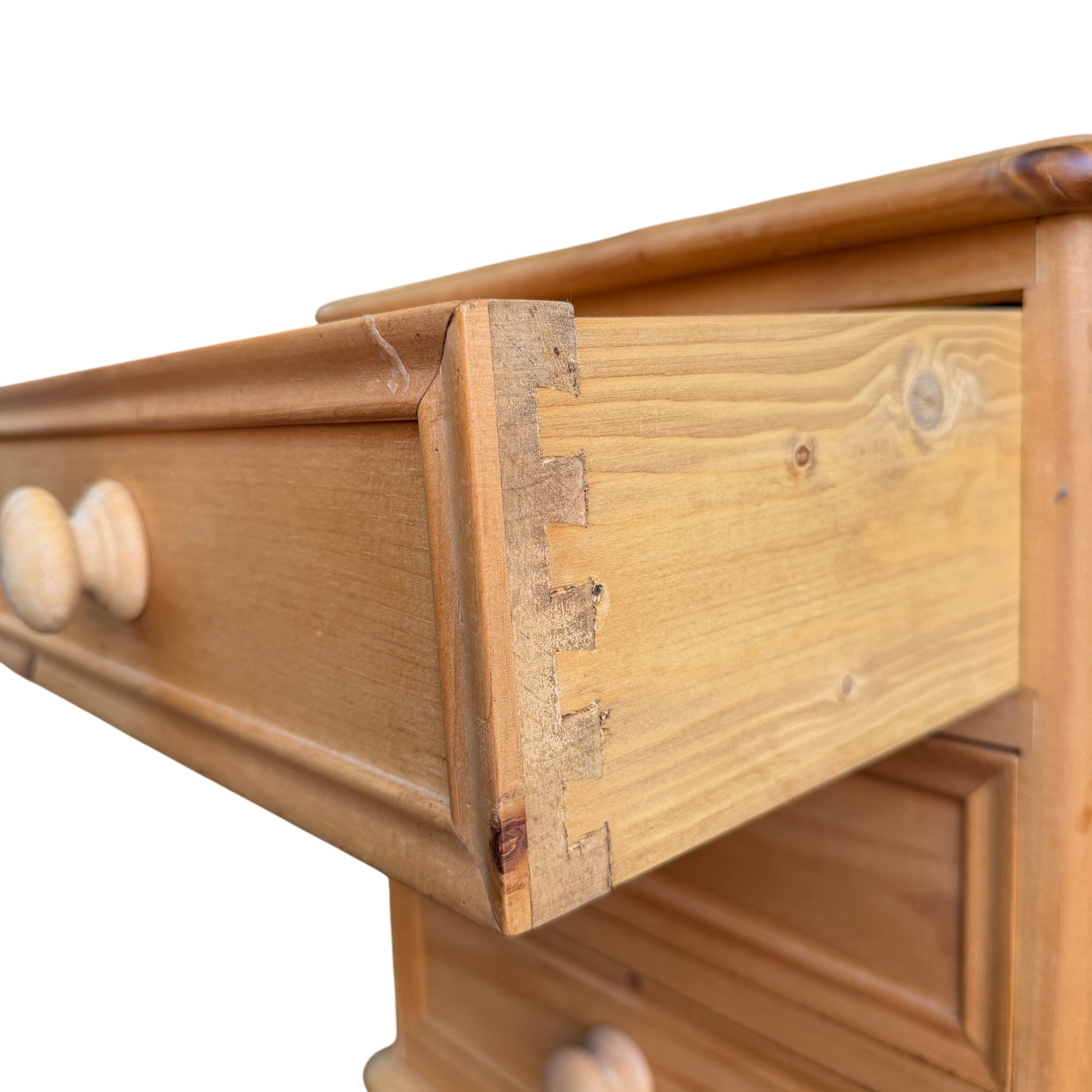 Close-up of pine wood grain and darker knot mark at top edge
