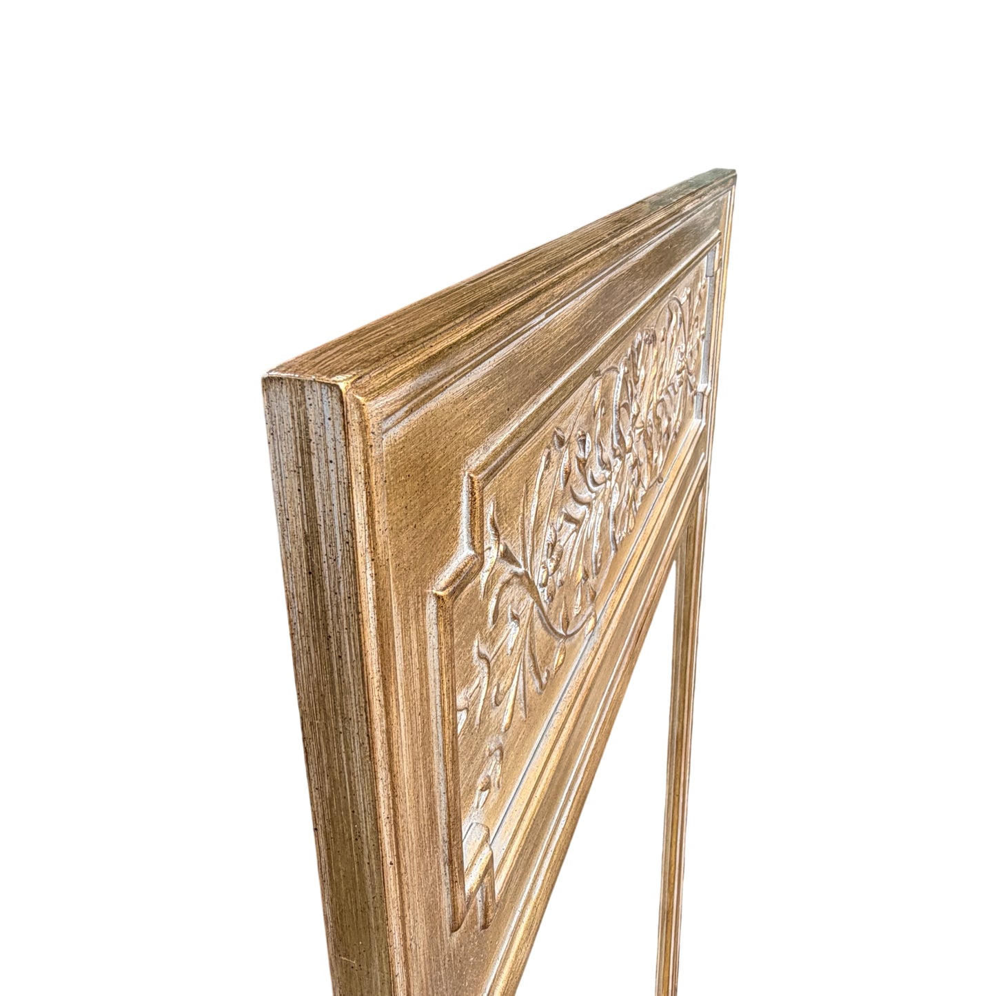 Carved decorative top panel on contemporary gilt mirror with floral motif