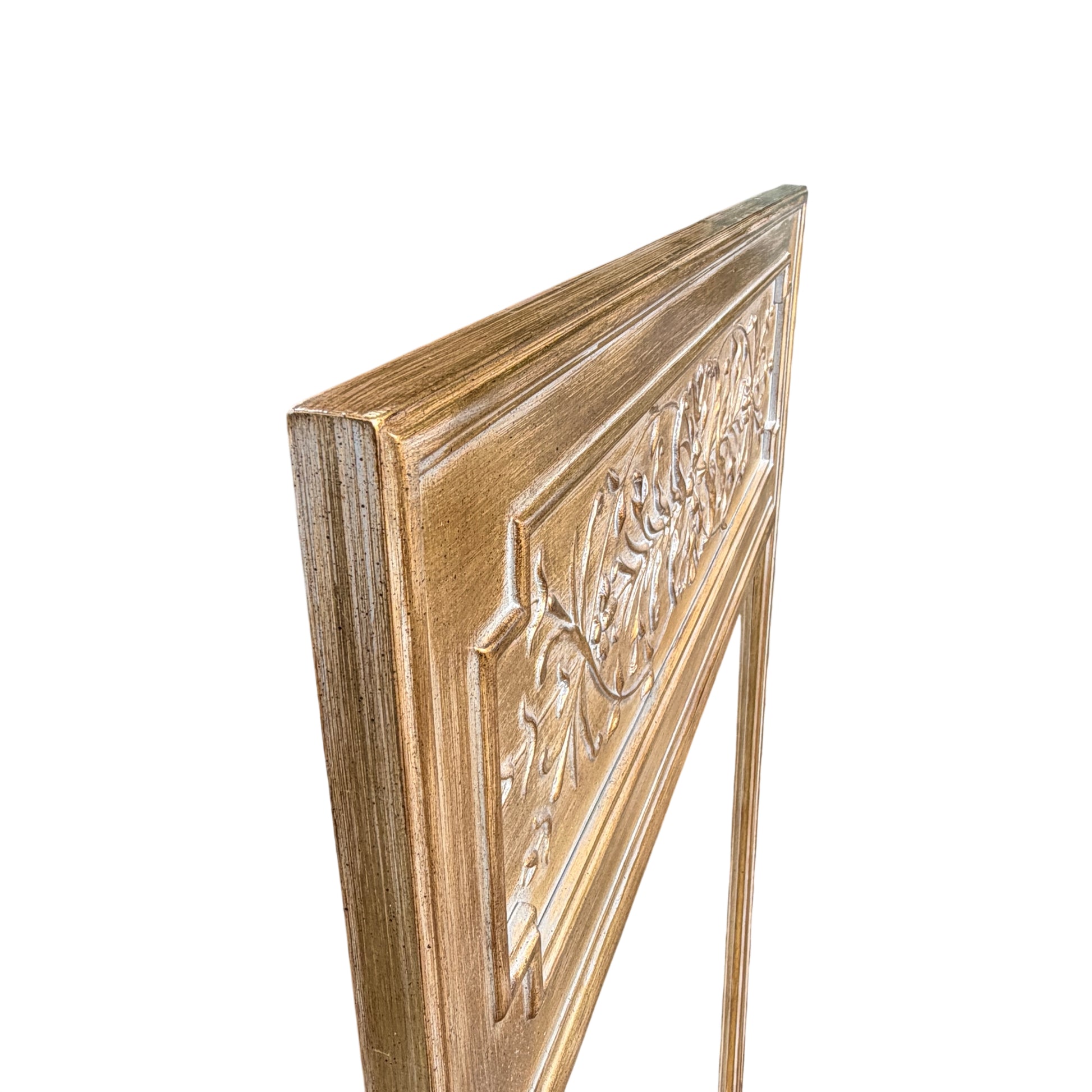Carved decorative top panel on contemporary gilt mirror with floral motif