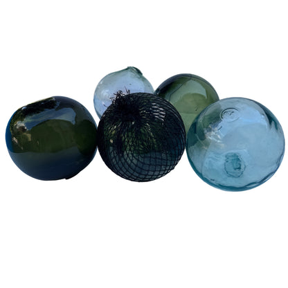 Collection of vintage glass buoys with bubbles and mould lines typical of hand-blown glass