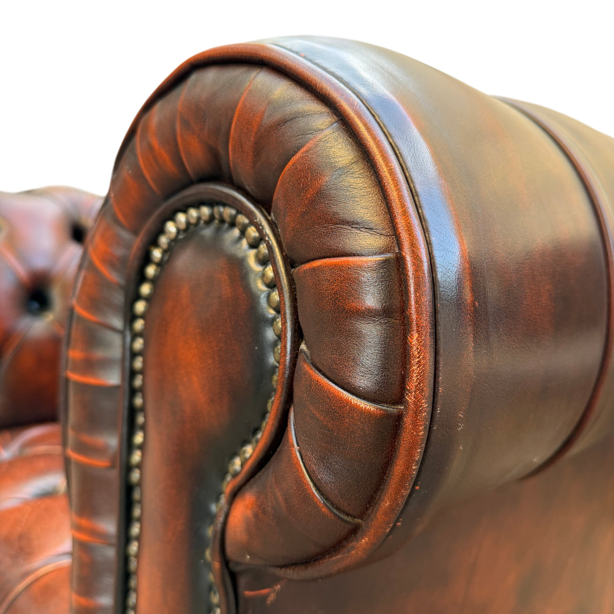 Detail of leather creasing and patina on button tufted Chesterfield seat