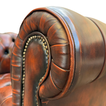 Detail of leather creasing and patina on button tufted Chesterfield seat