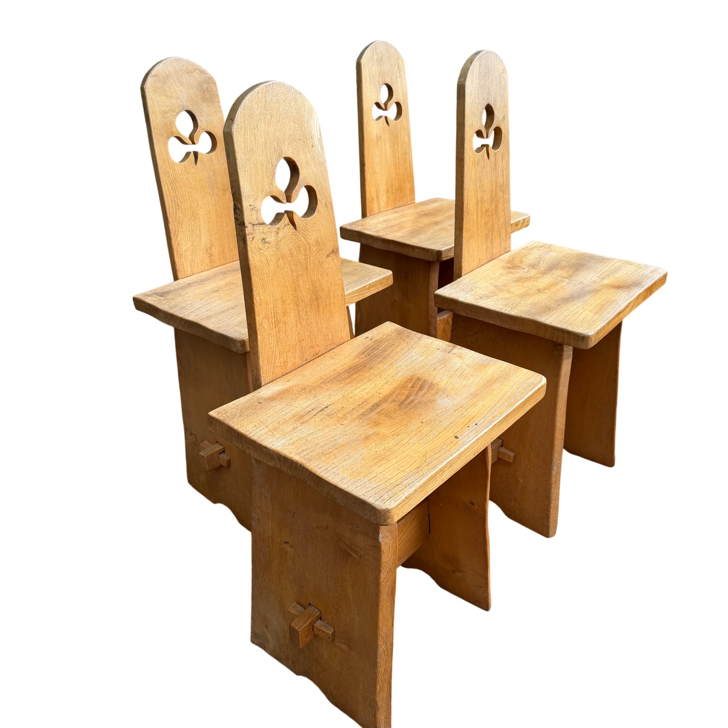 Solid oak wooden dining chairs with carved cut-out detail in the backrests