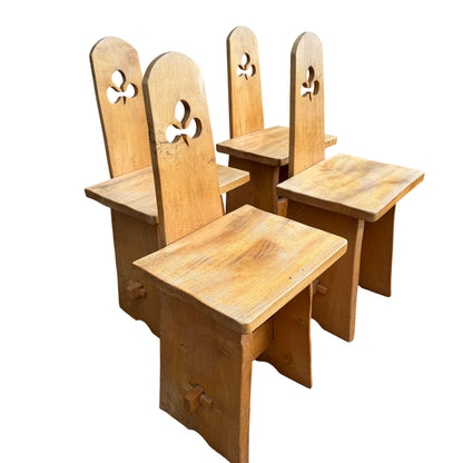 Solid oak wooden dining chairs with carved cut-out detail in the backrests
