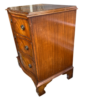 Front view of small mahogany chest of drawers with three drawers and brass handles