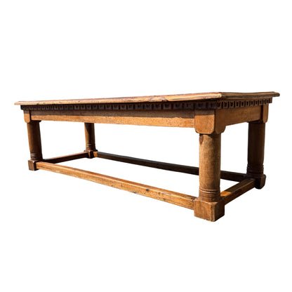 Side view of Victorian oak coffee table showing carved apron and turned leg detail