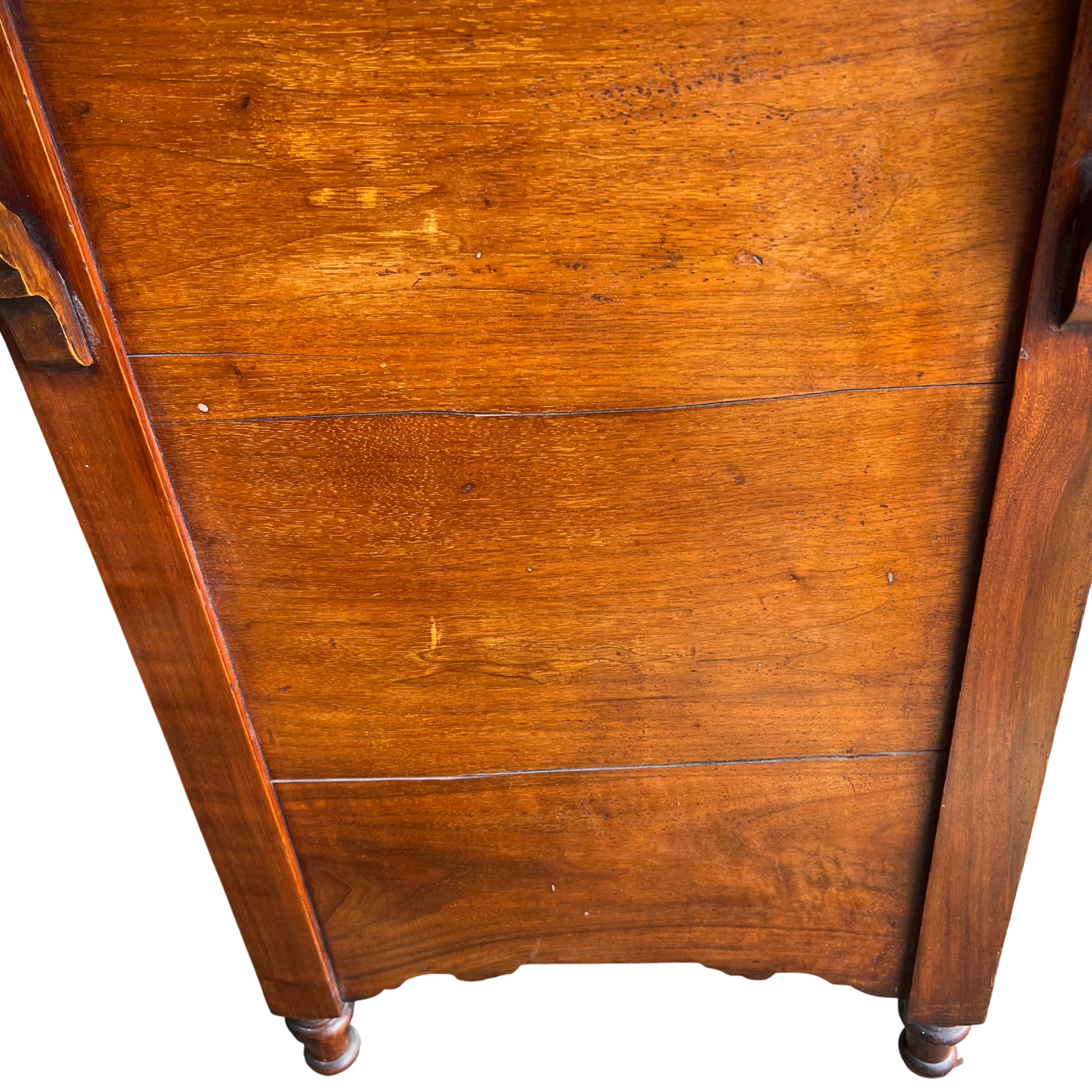 Detail of turned front leg with castor on antique oak chest