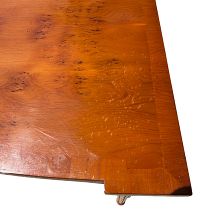 Side view of narrow burr-veneer hall table showing turned leg profile