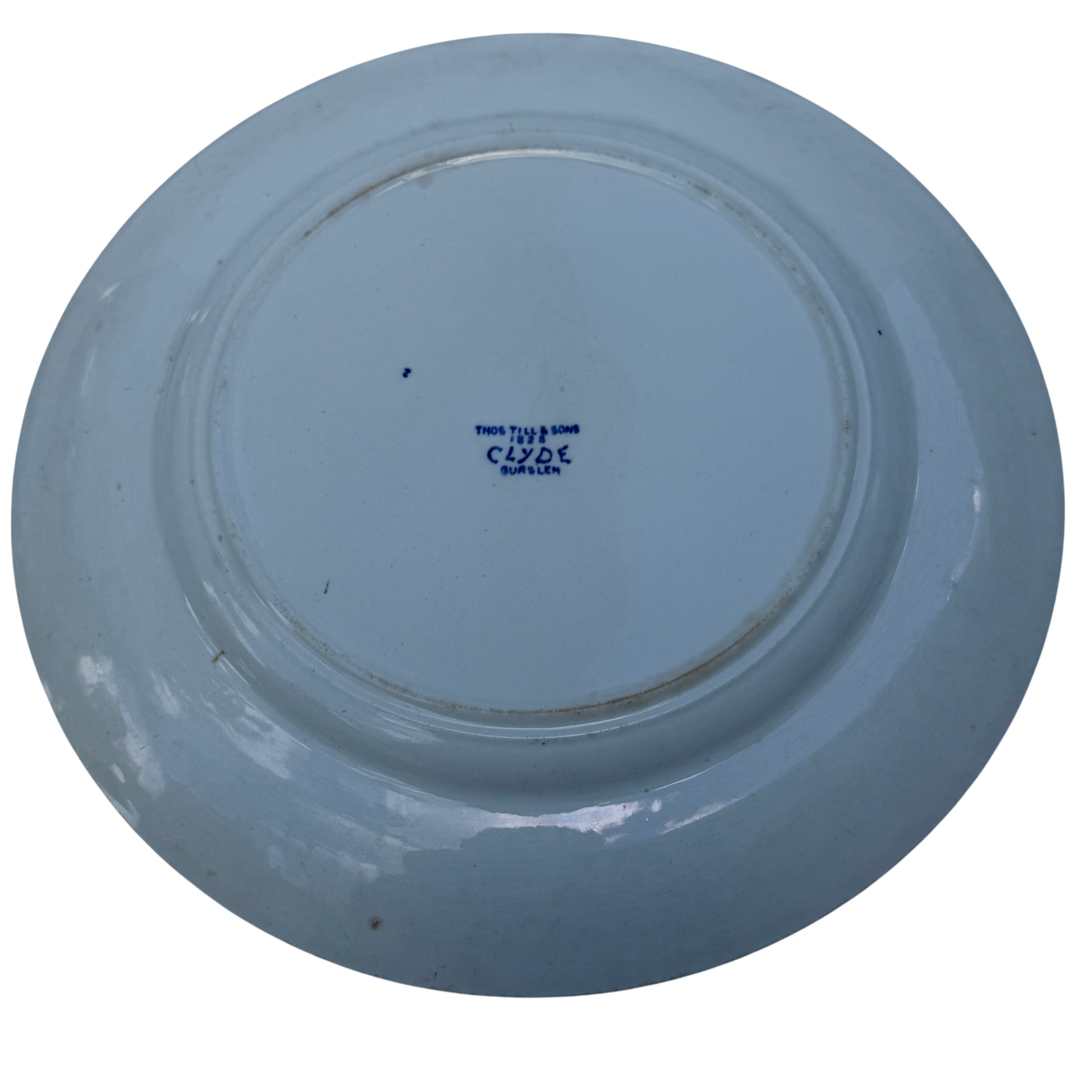 Angled view of Thomas Till & Sons Clyde plate showing cranes and bridge in blue transferware