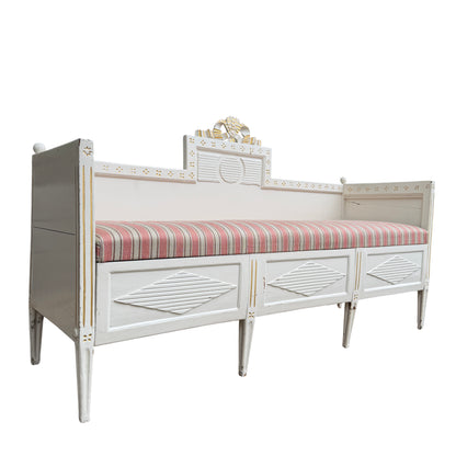 Vintage French-style painted daybed with removable striped cushion and carved crest detail