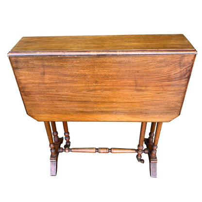 Folded tilt-top oak occasional table showing narrow profile and moulded edge