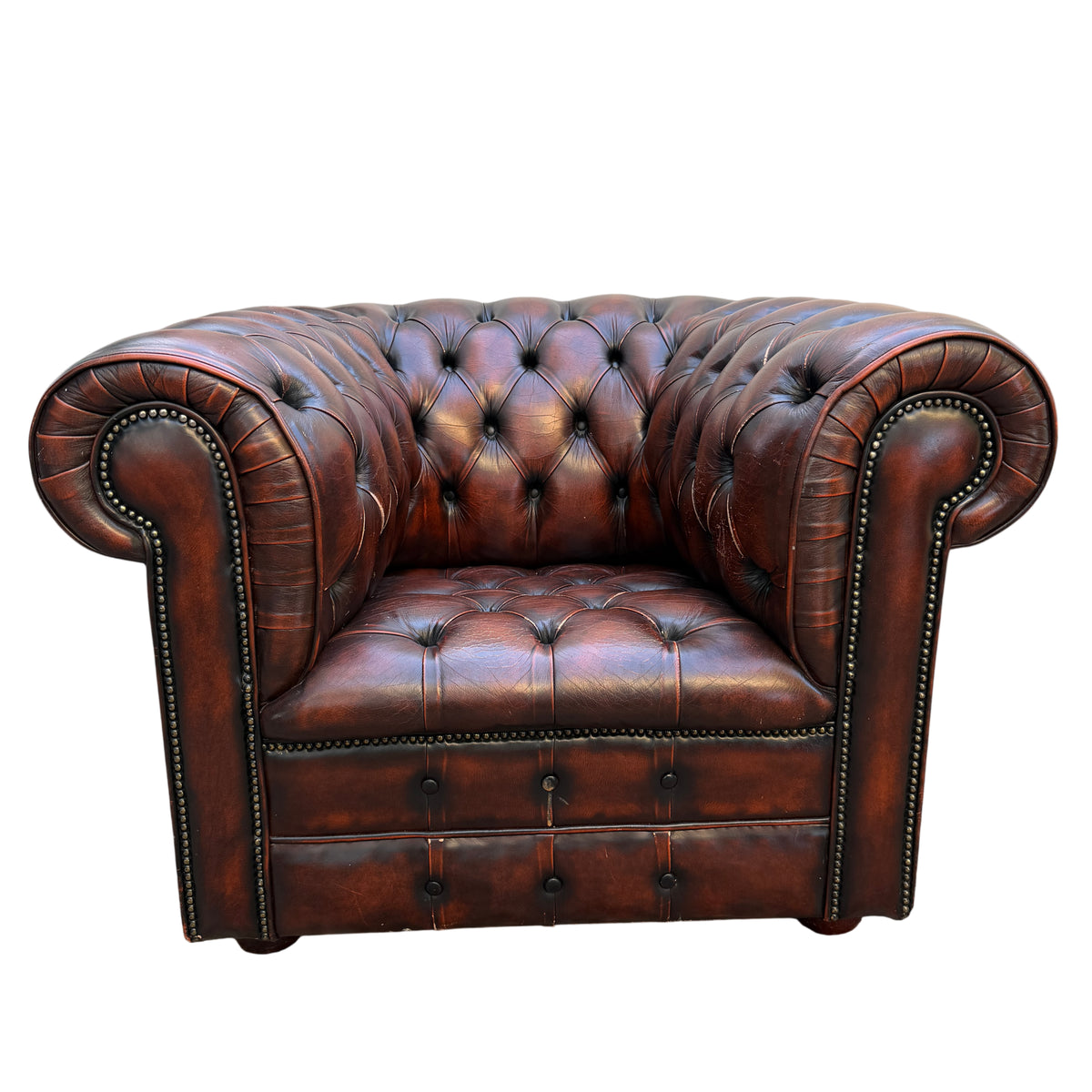 Front view brown leather Chesterfield armchair with deep button tufting and rolled arms