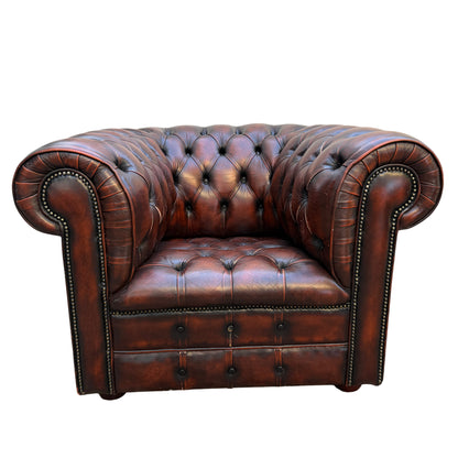 Front view brown leather Chesterfield armchair with deep button tufting and rolled arms