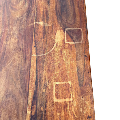 Base and plinth of solid wood six-drawer chest showing scuffs and wear