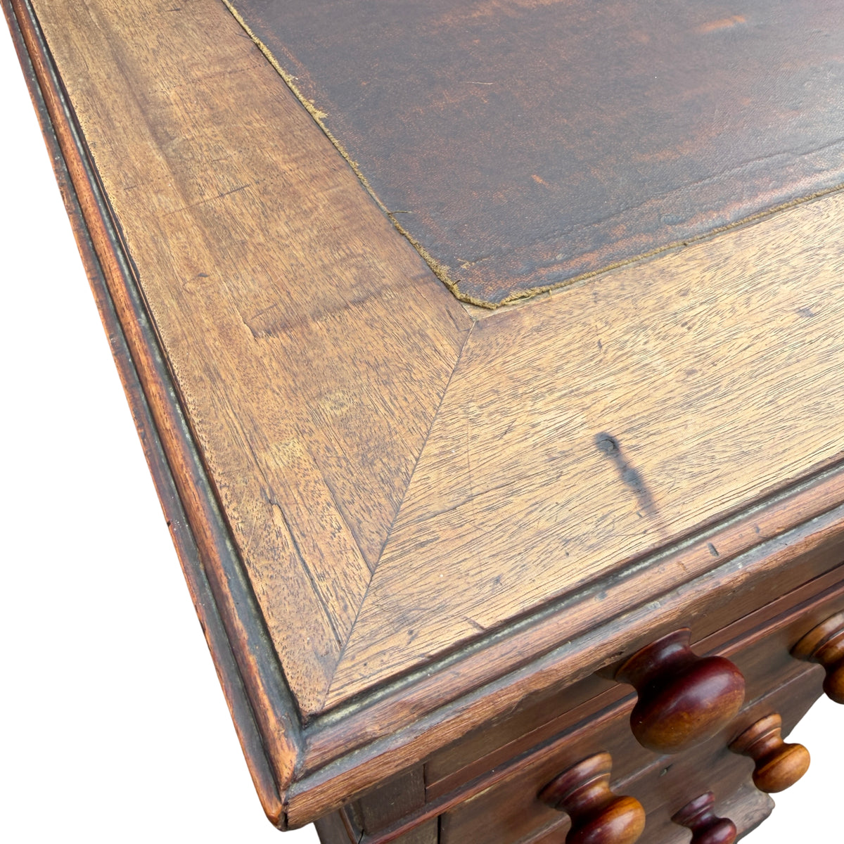 Top edge of desk showing inset leather panel and timber surround