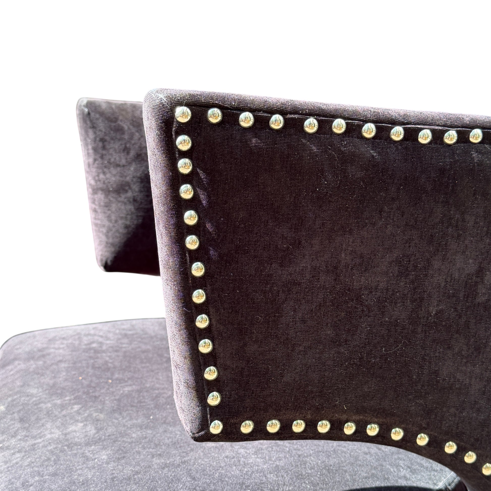 Rear view of wingback chair showing shaped back and dark upholstery panels