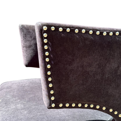 Rear view of wingback chair showing shaped back and dark upholstery panels