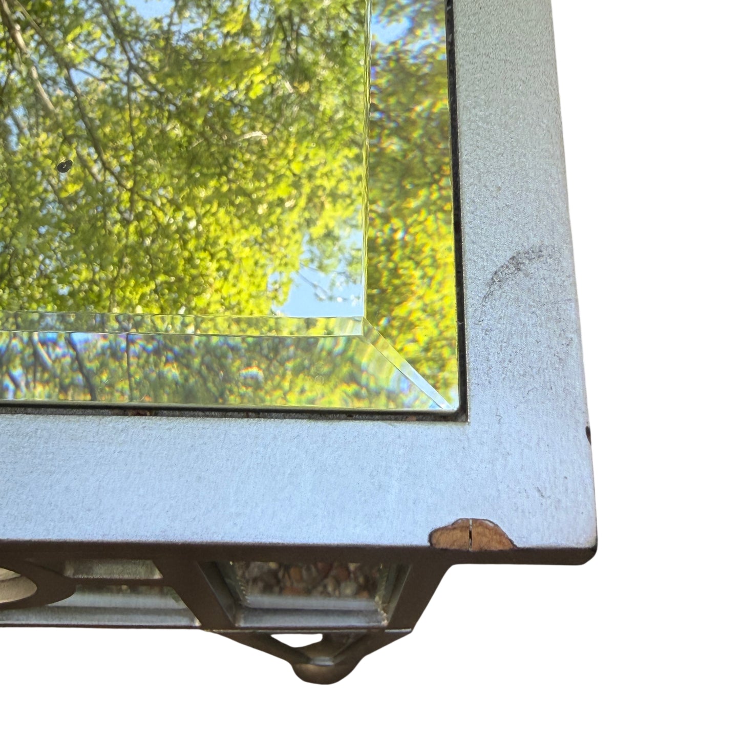 Angle view of two mirrored side tables showing glass reflections and silver frame