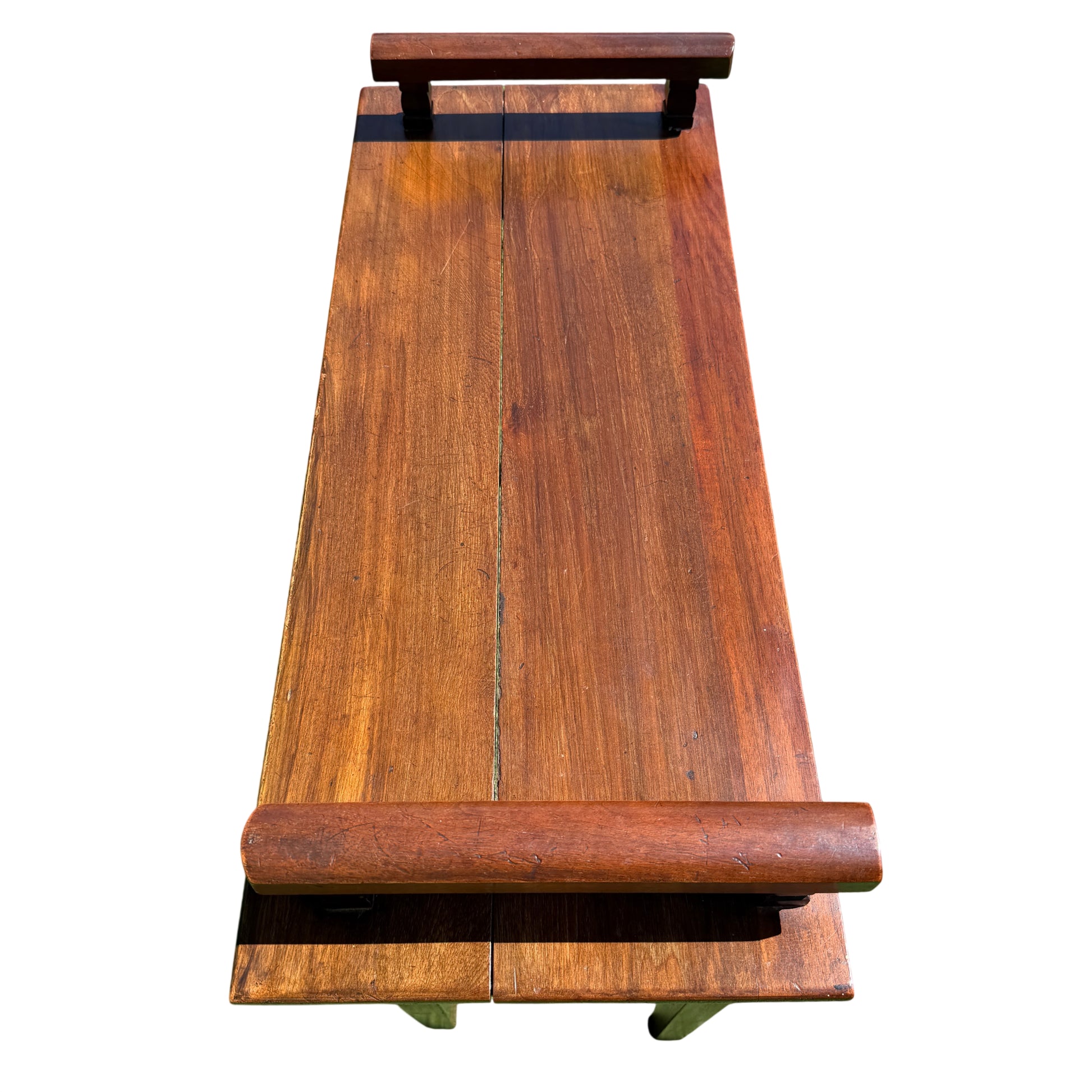 Angle view showing one leg with evidence of filled repair on the mahogany table