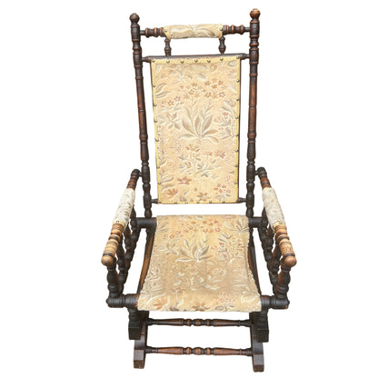 Close-up of floral tapestry upholstery on Victorian rocking chair backrest
