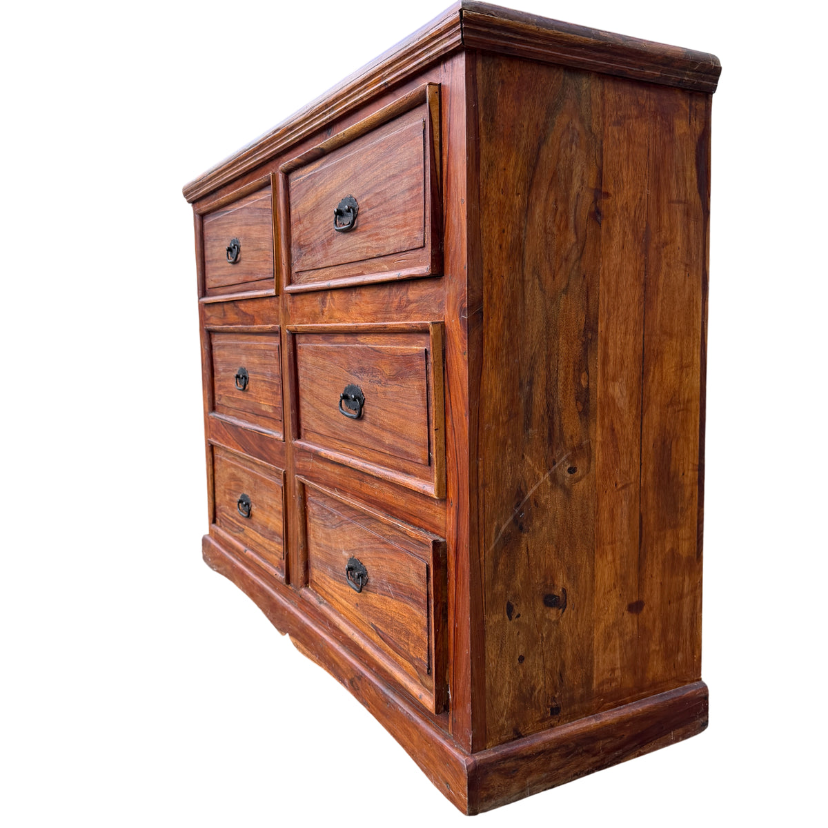 Close-up of top edge showing moulded top and worn finish of a wooden chest of drawers