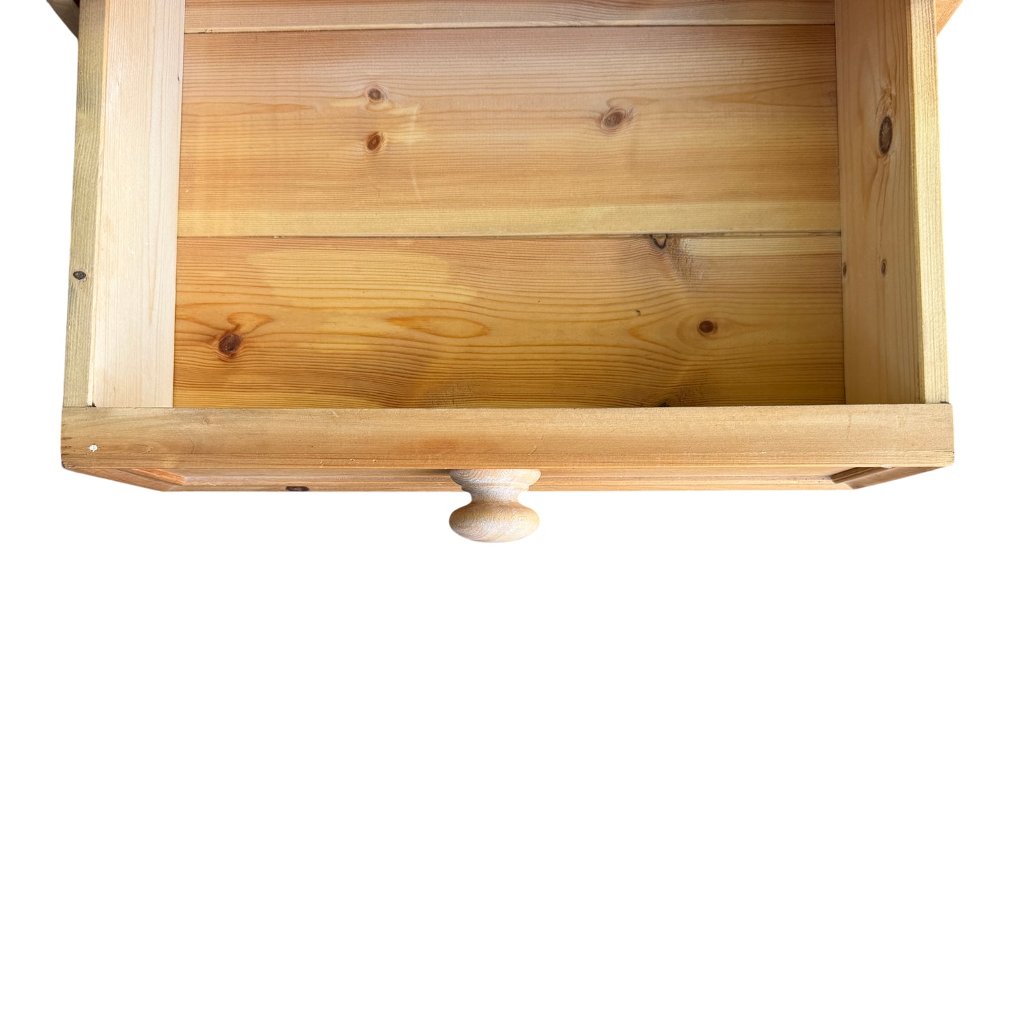 Side view showing pine bedside cabinet profile and corner wear