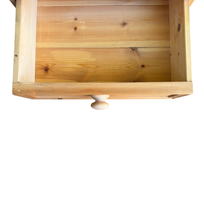 Side view showing pine bedside cabinet profile and corner wear