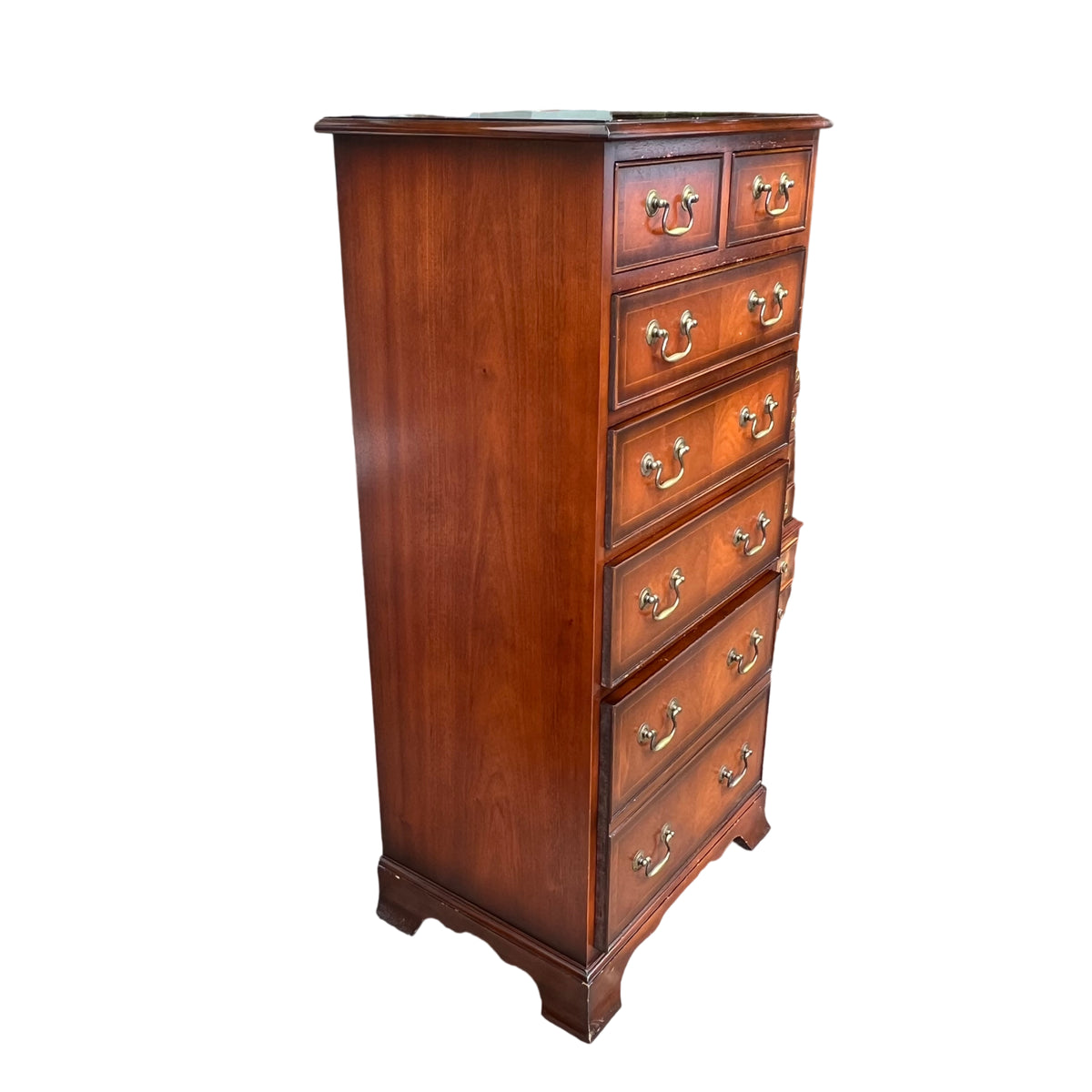 Detail of brass swan neck handles on vintage mahogany chest of drawers