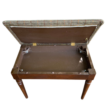 Front view of green tweed piano stool style bench with turned legs