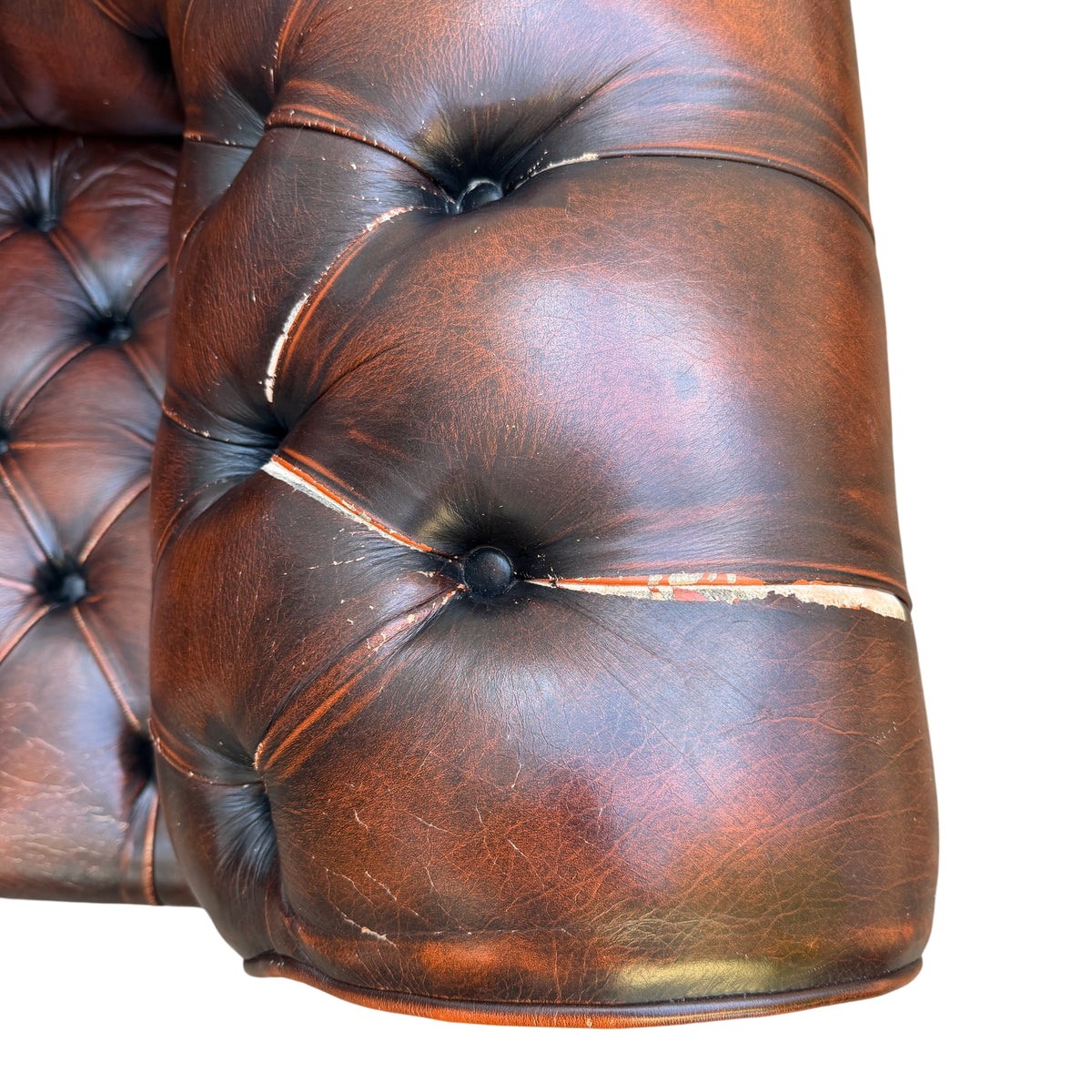 Buttoned seat and tufted leather cushion on a vintage-style Chesterfield armchair