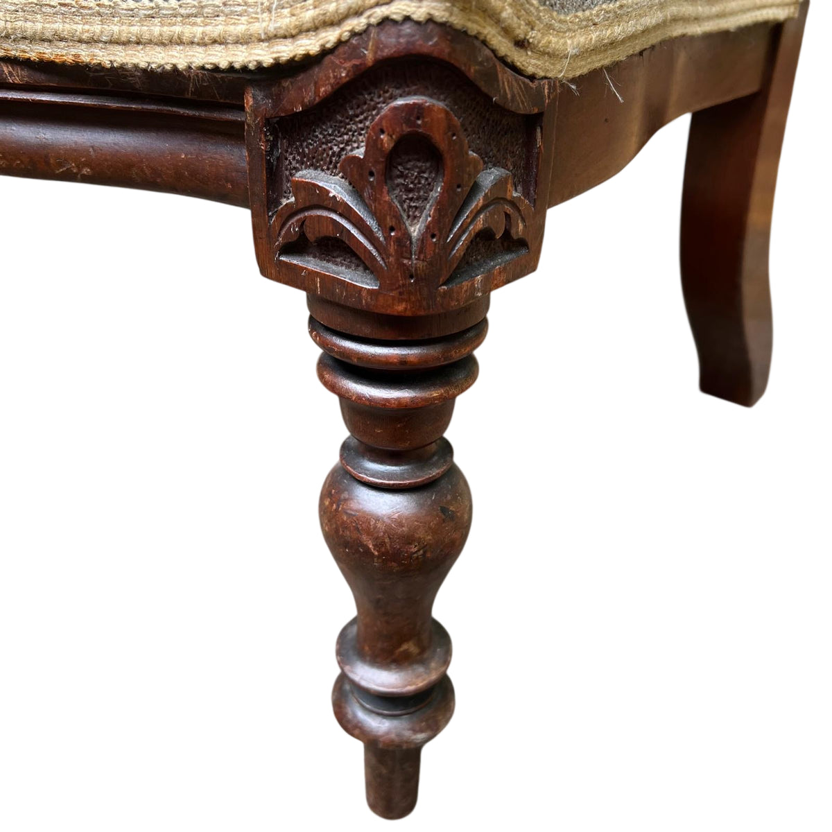 Carved floral crest detail on top rail of Victorian chair