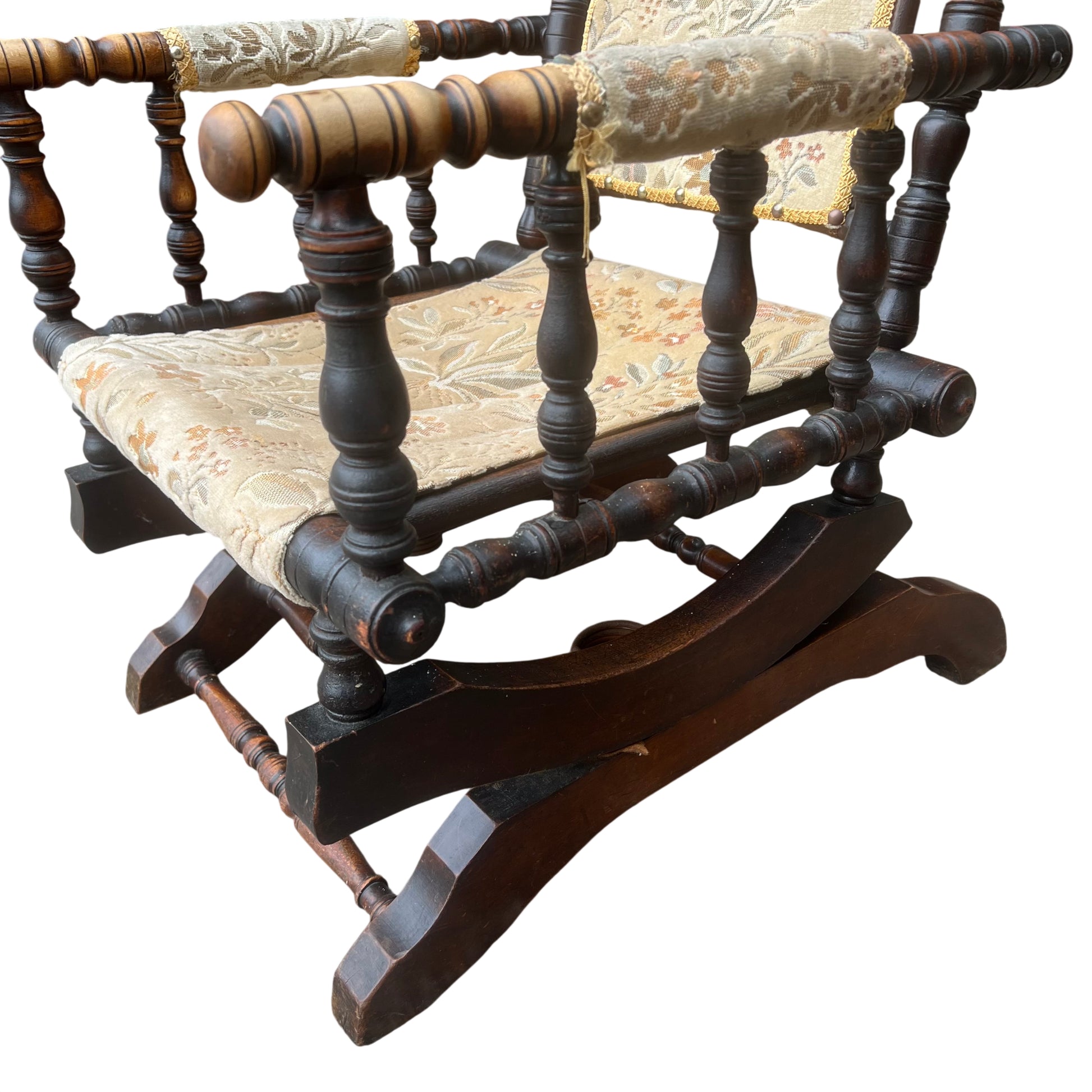 Side view of wooden curved rocker base and turned stretcher on vintage armchair