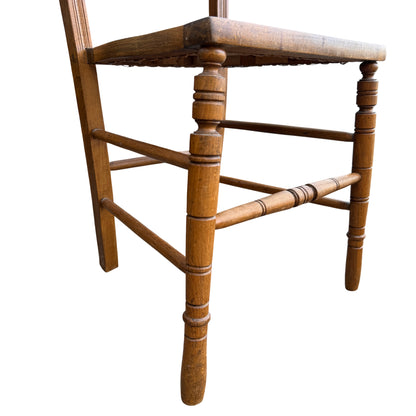 Worn finish and small surface scratches on wooden dining chair frame