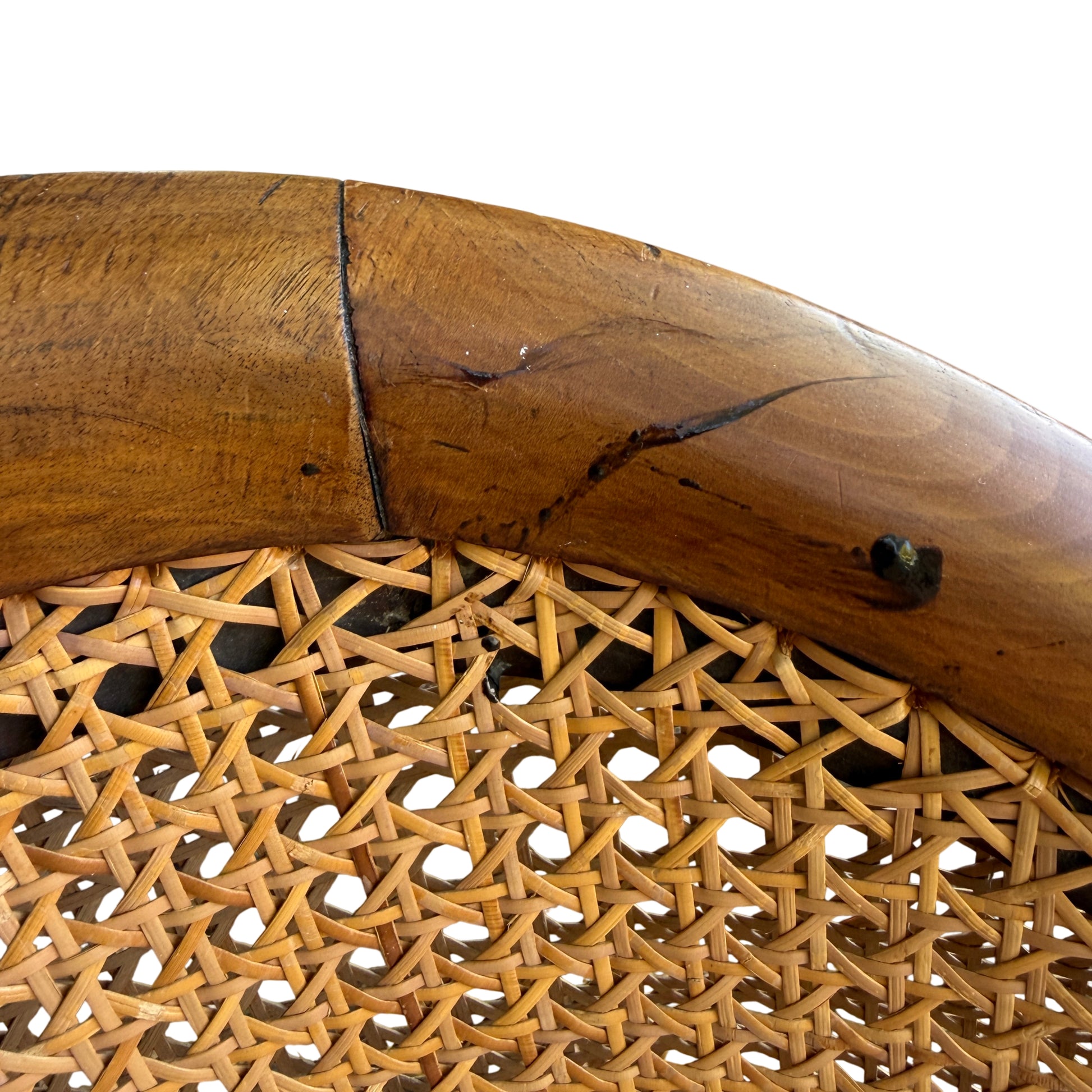 Carved cabriole leg ending in carved claw-style foot on cane-back armchair