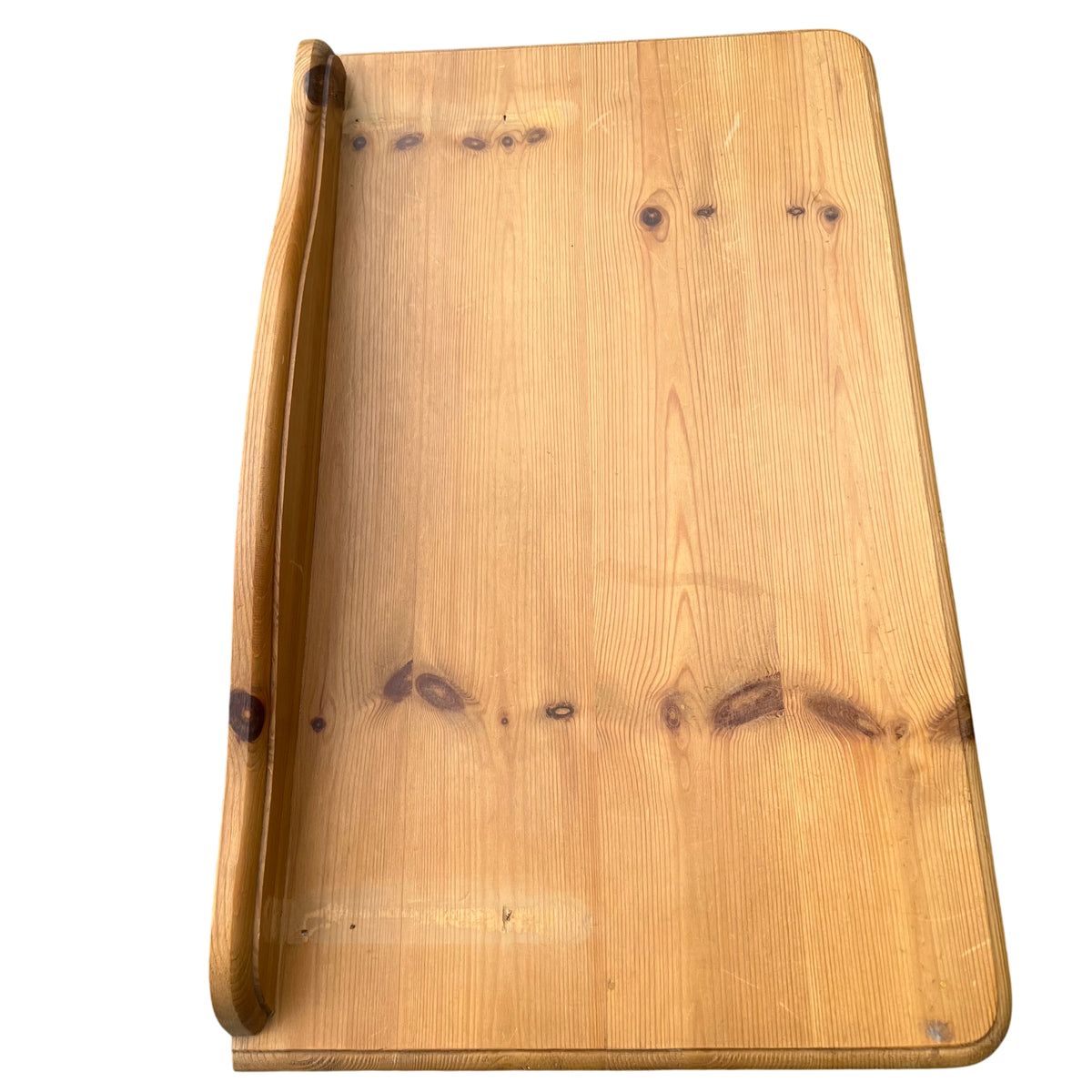 Side view showing turned legs and curved apron of pine hall table