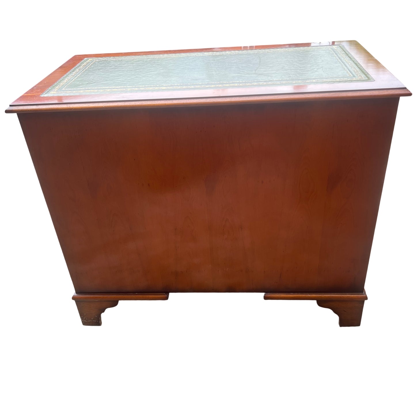 Open central cupboard of kneehole desk showing internal wood panels and key